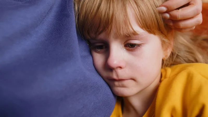 Bullying in schools can often leave students feeling isolated and vulnerable. In this emotional moment, a child seeks comfort and reassurance from an adult, showing the importance of providing emotional support. Schools should offer a safe space for students to express their feelings and address bullying, helping them heal and regain confidence.