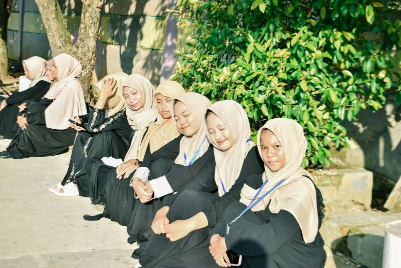 Students sitting outdoors during a school activity at abu dhabi english schools