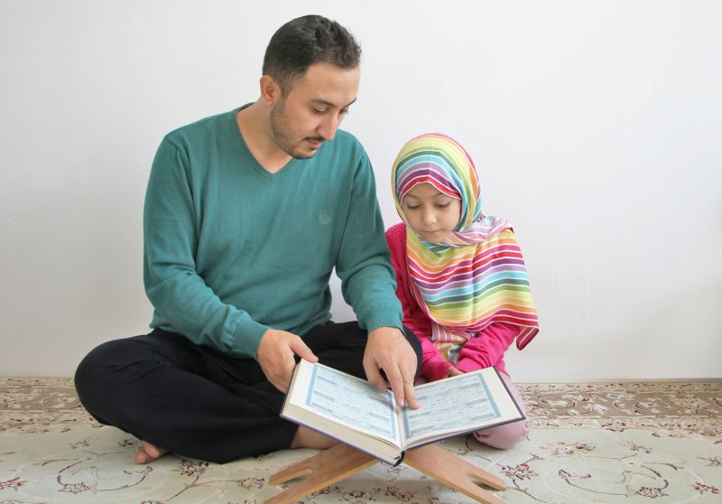 Parent guiding a child through reading in a personalized learning program