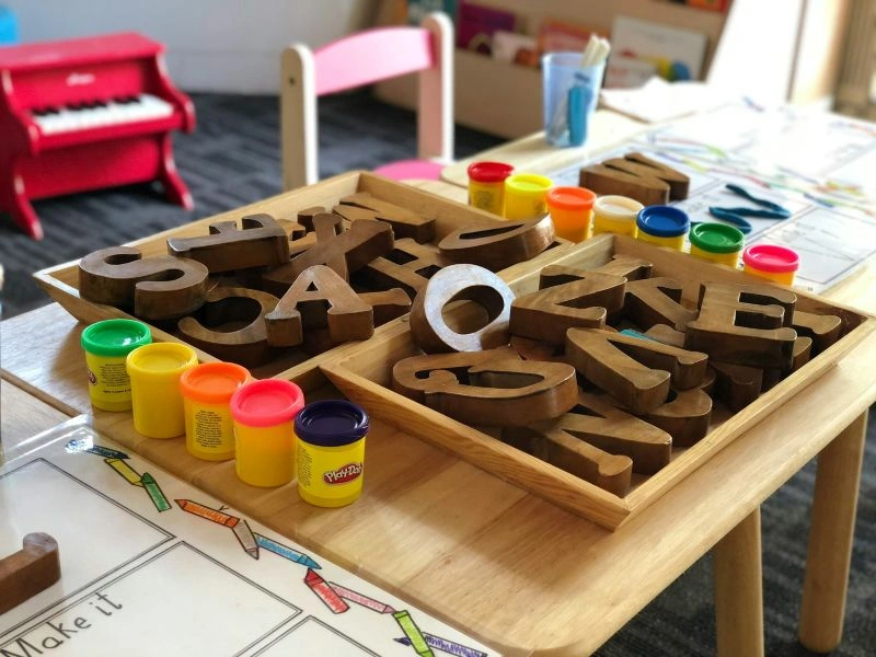 Preschool learning materials with alphabet letters and play activities that support early literacy skills