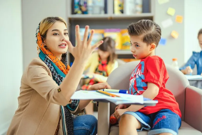 Independent Learning with a child practicing communication and problem-solving skills during a guided educational activity.
