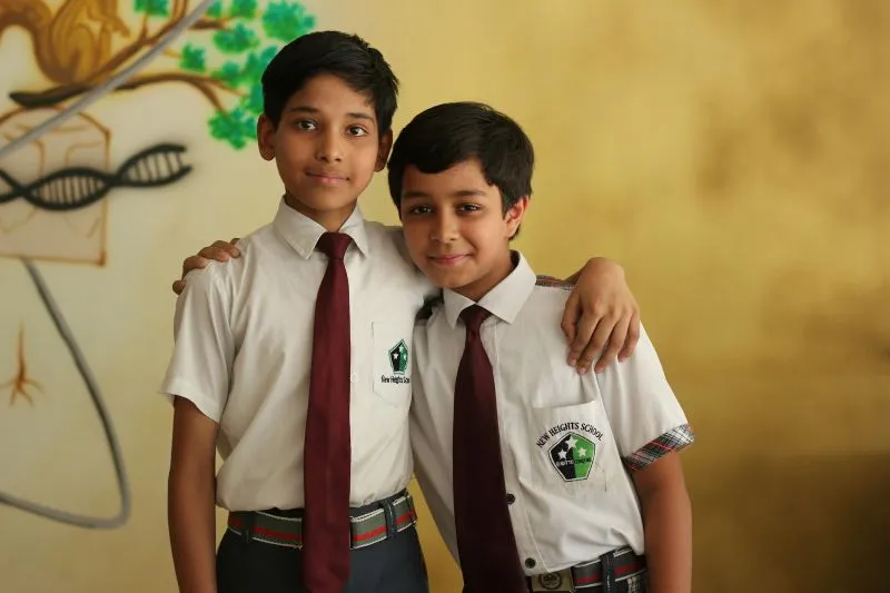 Abu Dhabi Schools For Expats featuring students in uniforms spending time together and creating a supportive learning community.