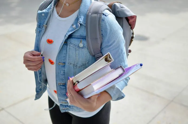 Getting Ready For School with a student carrying books, notebooks, and a backpack while preparing for the school day.